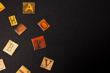 random letters of alphabet on black background with copy space