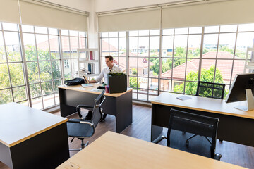 Last man sit in empty office looking at photo frame of his family, bankrupted business during economy crisis