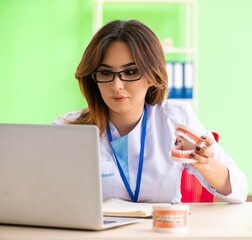 Woman dentist working on teeth implant