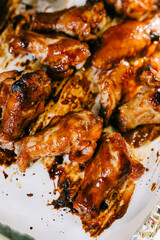 A tray of sticky glazed barbecue chicken wings straight from the oven. 