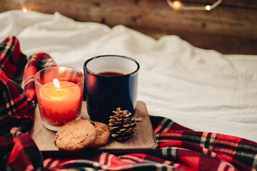 Flat lay winter and autumn cozy vintage background with copy space. The cup of tea or coffee on wooden background. Christmas atmosphere.