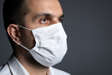 Doctor posing with mask gray background