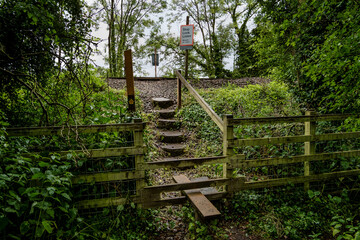 Railway pedestrian crossing from wooded park area