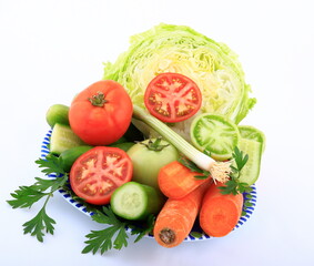 Green and red vegetable composition on white background.