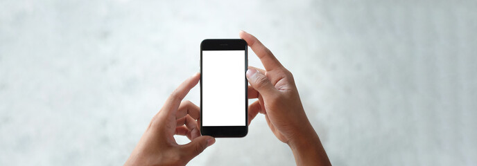 Cropped shot view of man hands holding smart phone with blank copy space screen for your text message or information content, female reading text message on cell telephone during in urban setting.
