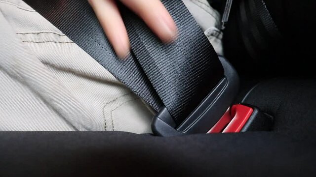 A married adult man fastening his seal belt for his safety and for the safety of his family