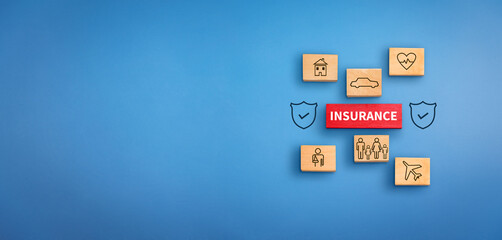 wooden block with text insurance, icons  and shield icon at background. Insurance  concept,...