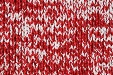 Mottled red and white handmade knitted texture. Marl yarn knitting. Colorful woolen fabric background. 