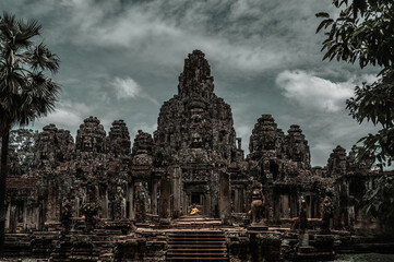 Ancient temple Angkor Thom in Siem Reap, Cambodia. Statue of Buddha in the middle of the temple next to the entrance.