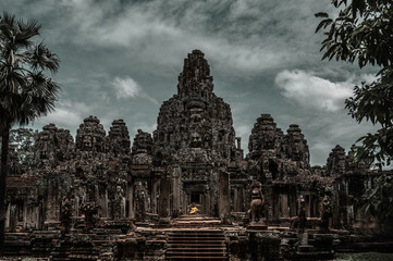 Ancient temple Angkor Thom in Siem Reap, Cambodia. Statue of Buddha in the middle of the temple...