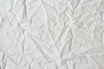 Old white wrinkled fabric texture. Crumpled cotton woven material for background. Top view