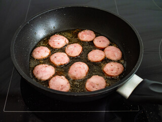 Frying sausage slices  in pan