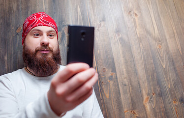 bearded man  holding smart phone