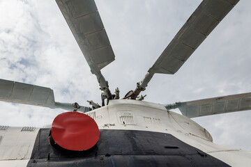 The propeller of the helicopter close-up against a gray sky.
