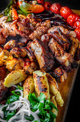 Assorted Mixed different grilled meat with vegetables on table