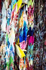 Close up of colorful garlands flanking that are made of thousands of origami paper cranes