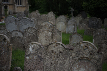 packed cemetery with old decaying gravestones in church churchyard