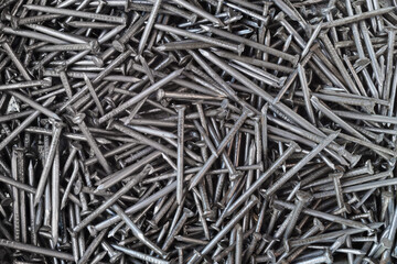 Many small silver color metal nails for background or wallpaper. Closeup. Top view
