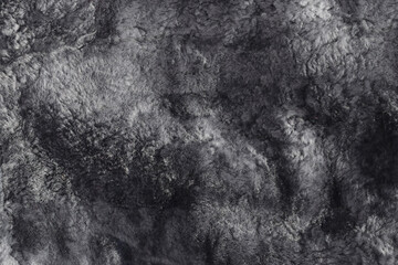 Used lambskin material. Texture of natural sheepskin. Worn uneven gray fur background. Top view....