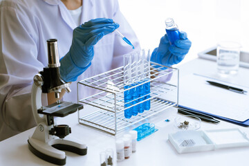 Scientist wear lab coat and protective wear are working with research or doing investigations with...