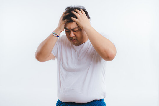 Overweight Asian Men With Headache Isolated On White Background.