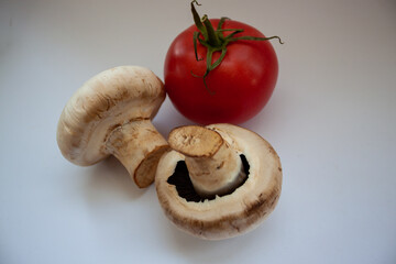 Fresh ripe vegetables for summer salad. Mushrooms and tomatoes. Tomatoes and mushrooms