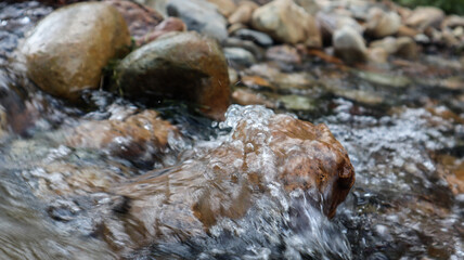 The water flows through the stone crevices.