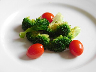 broccoli and tomatoes on a plate