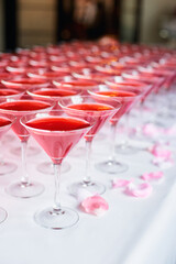Table setting for party. Wineglasses with pink martini.