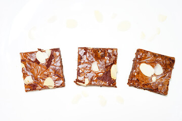 3 Almond Brownies on white background