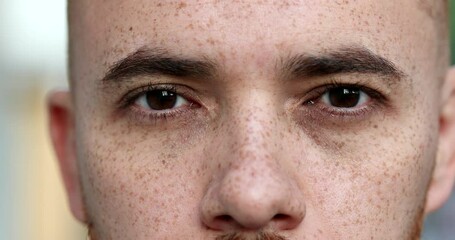 Handsome white man opening eyes feeling serene and relaxed. Close-up person eyes concentrating