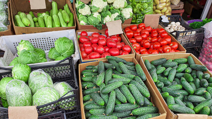 Sale of fresh and organic fruits and vegetables at the farmers market. In the boxes for choosing there are products for a healthy diet.