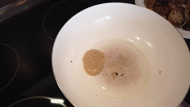 A close-up of pancakes that are frieding in a frying pan