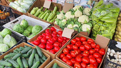 Sale of fresh and organic fruits and vegetables at the farmers market. In the boxes for choosing there are products for a healthy diet.