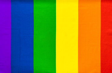 Rainbow LGBT flag of six colors for design with space for text. Gay pride rainbow. Copy space. Symbol of the LGBT movement. Rainbow silk fabric.