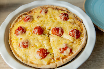 Homemade quiche lorraine with chicken, tomatoes and cheese. French cuisine. Selective focus. Top view. Copy space