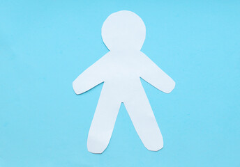 Flat lay  black, yellow, white paper people holding hands on blue background, top view. Unity...