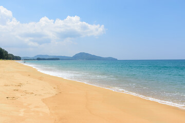 Fototapeta na wymiar Beautiful tropical landscape beach sea and sand with blue sky in Mai Khao Beach,Phuket, Thailand .