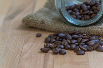 Close up of Roasted coffee beans on  wooden background with copy space. - 355904840