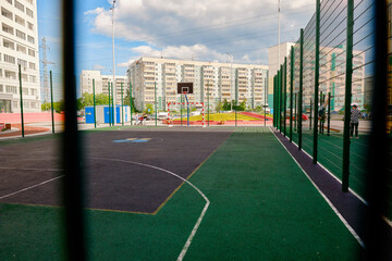 Soccer football and basketball field near the building of an apartment building. Empty playground for sports.