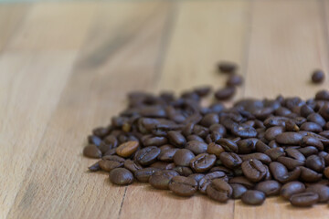 Selective focus of Roasted coffee beans on  wooden background with copy space. - 355904857