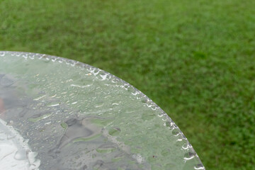 raindrop on Glass table with green grass  and blur background with copy space. - 355905453