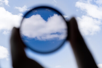 hand holds a circular polarizer filter Accessory for the photographer