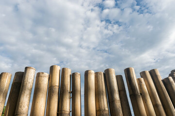 Bamboo wall with clouds and sky background. - 355906030