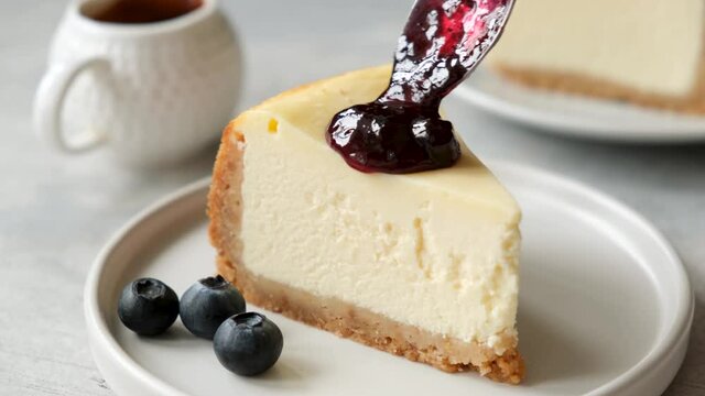 Slice of cheesecake with blueberry sauce. Serving cheesecake with blueberry jam