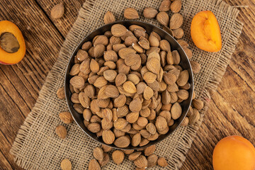 Vintage wooden table with shelled Apricot Kernels (selective focus)