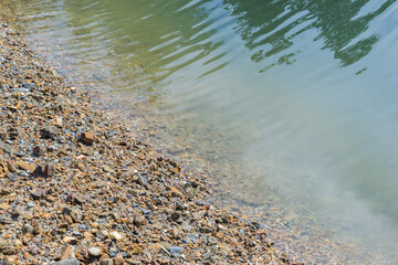 Pebbles on the riverbank in Thailand. - 355906626