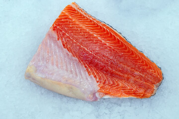 raw salmon steak close-up on the counters of a fish hypermarket. Sale of fresh red fish