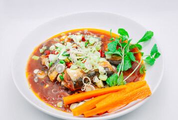 Spicy canned sardines salad on a white plate