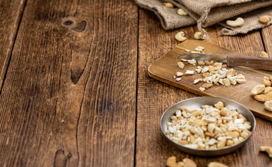 Obraz na płótnie Canvas Chopped Cashew nuts (close-up shots, selective focus)